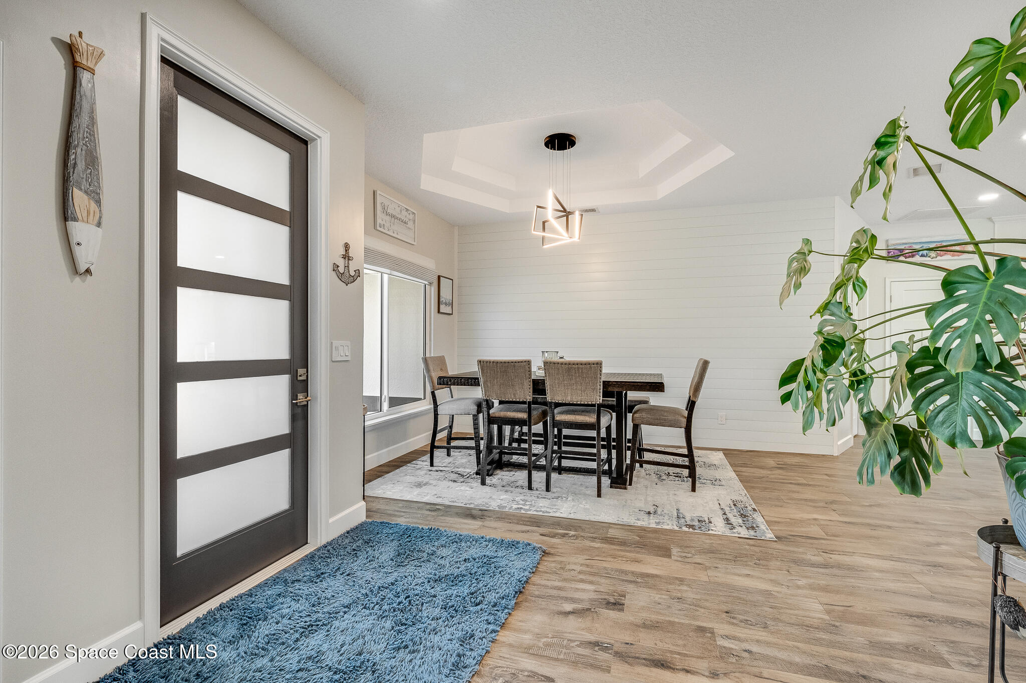 447 Sandy Key Melbourne Beach, FL 32951 - Photo 14 of 94 a view of a dining room with furniture and a potted plant