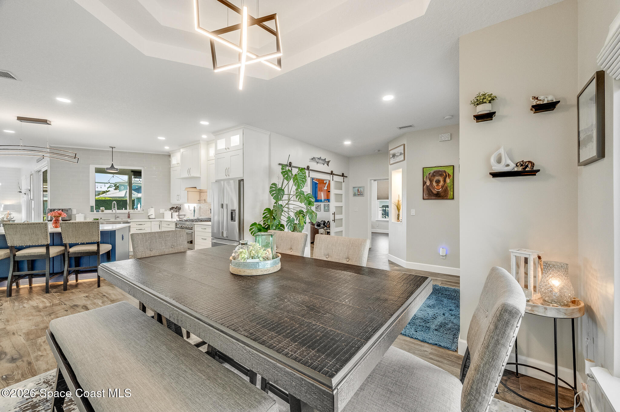 447 Sandy Key Melbourne Beach, FL 32951 - Photo 16 of 94 an open kitchen with dining table and chairs