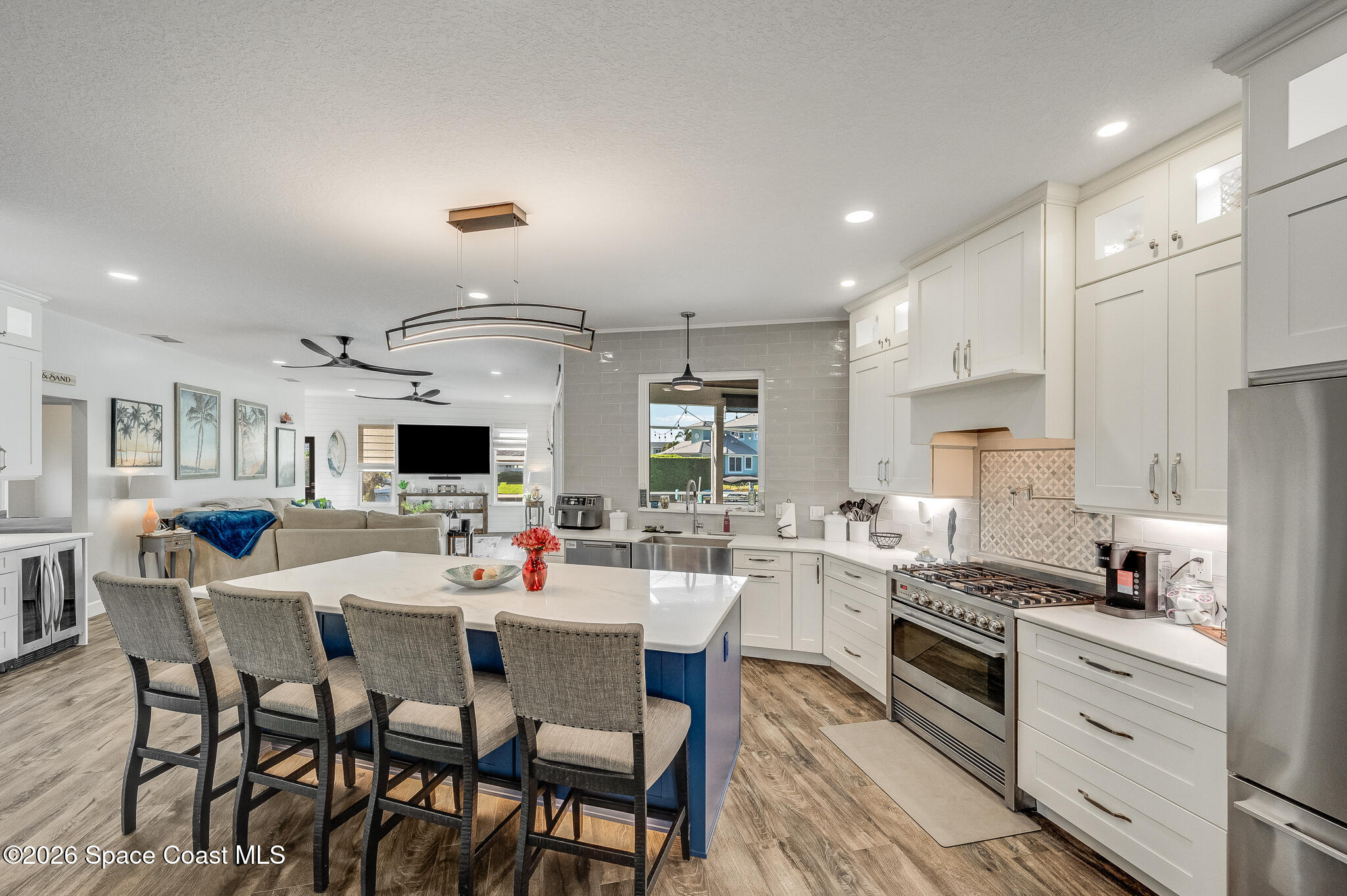 447 Sandy Key Melbourne Beach, FL 32951 - Photo 3 of 94 a kitchen with stainless steel appliances kitchen island granite countertop a sink and cabinets