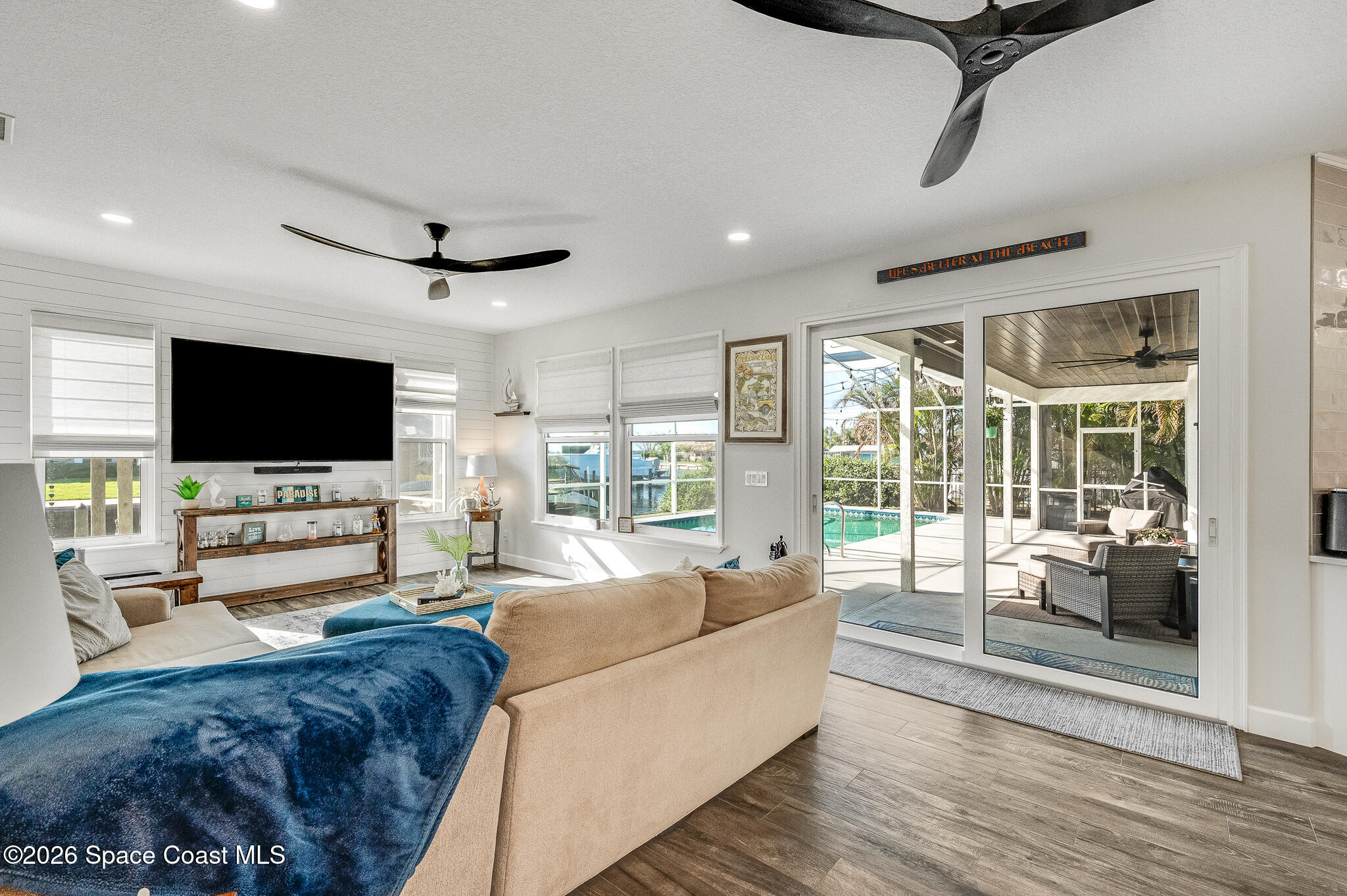 447 Sandy Key Melbourne Beach, FL 32951 - Photo 32 of 94 a living room with furniture and a flat screen tv