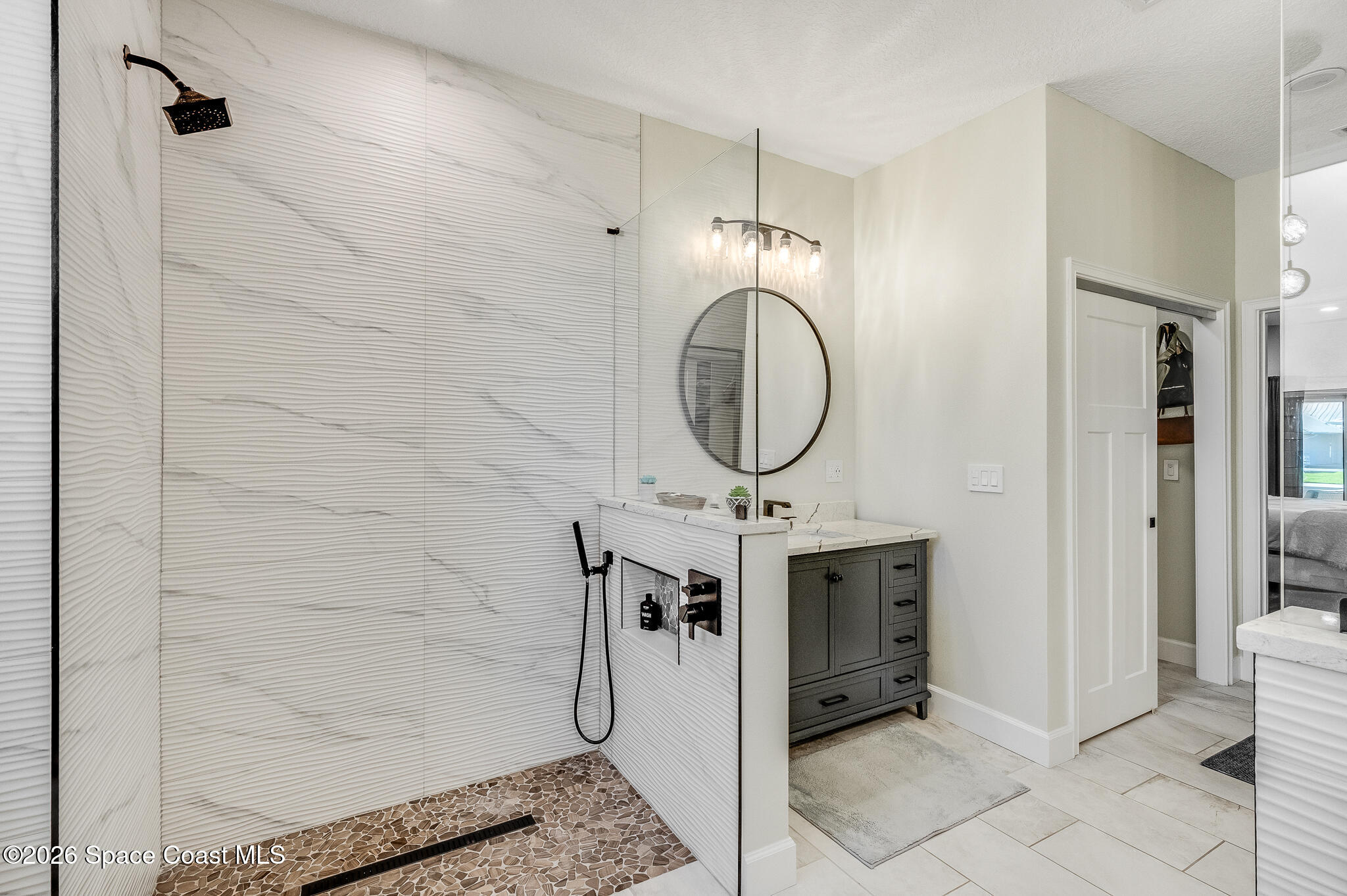 447 Sandy Key Melbourne Beach, FL 32951 - Photo 44 of 94 a bathroom with a granite countertop sink a mirror and a shower