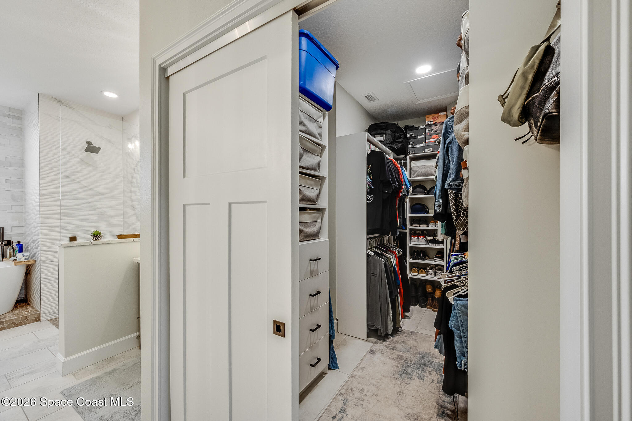 447 Sandy Key Melbourne Beach, FL 32951 - Photo 47 of 94 a view of walk in closet with clothes