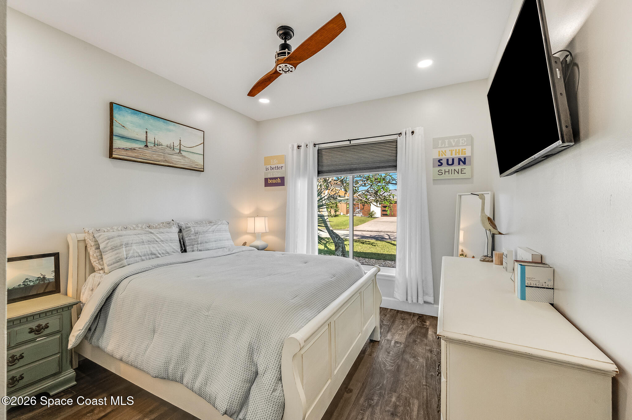 447 Sandy Key Melbourne Beach, FL 32951 - Photo 49 of 94 a spacious bedroom with a bed and a flat screen tv