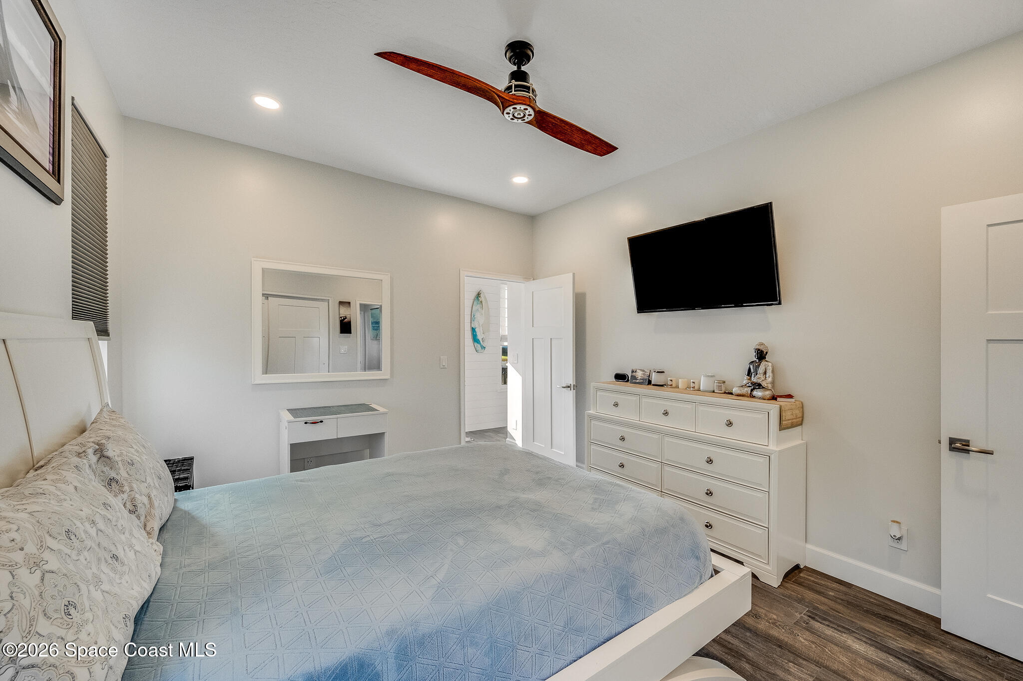 447 Sandy Key Melbourne Beach, FL 32951 - Photo 52 of 94 a bedroom with a large bed and a flat screen tv
