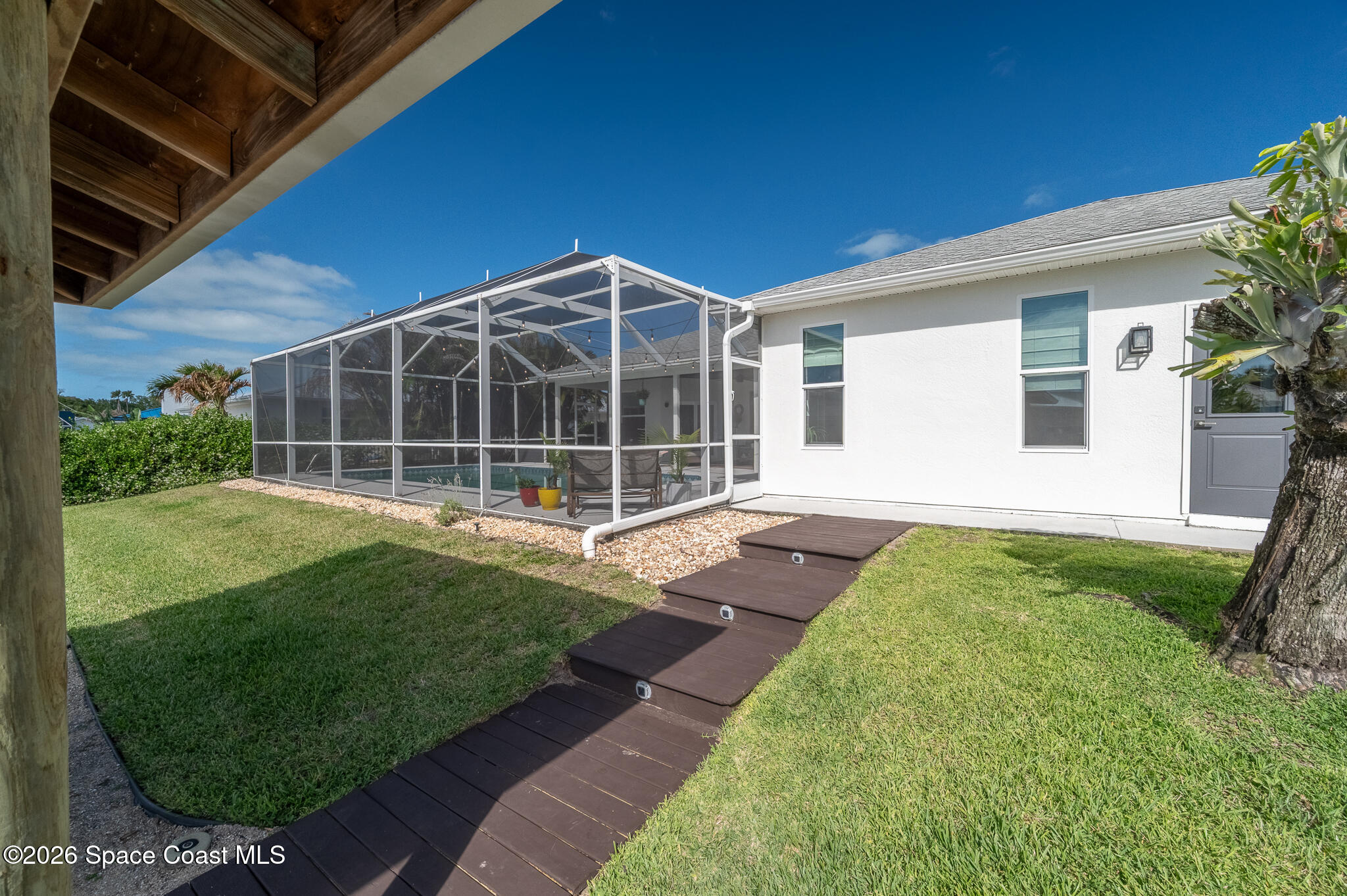 447 Sandy Key Melbourne Beach, FL 32951 - Photo 60 of 94 a view of a backyard with a garden and plants