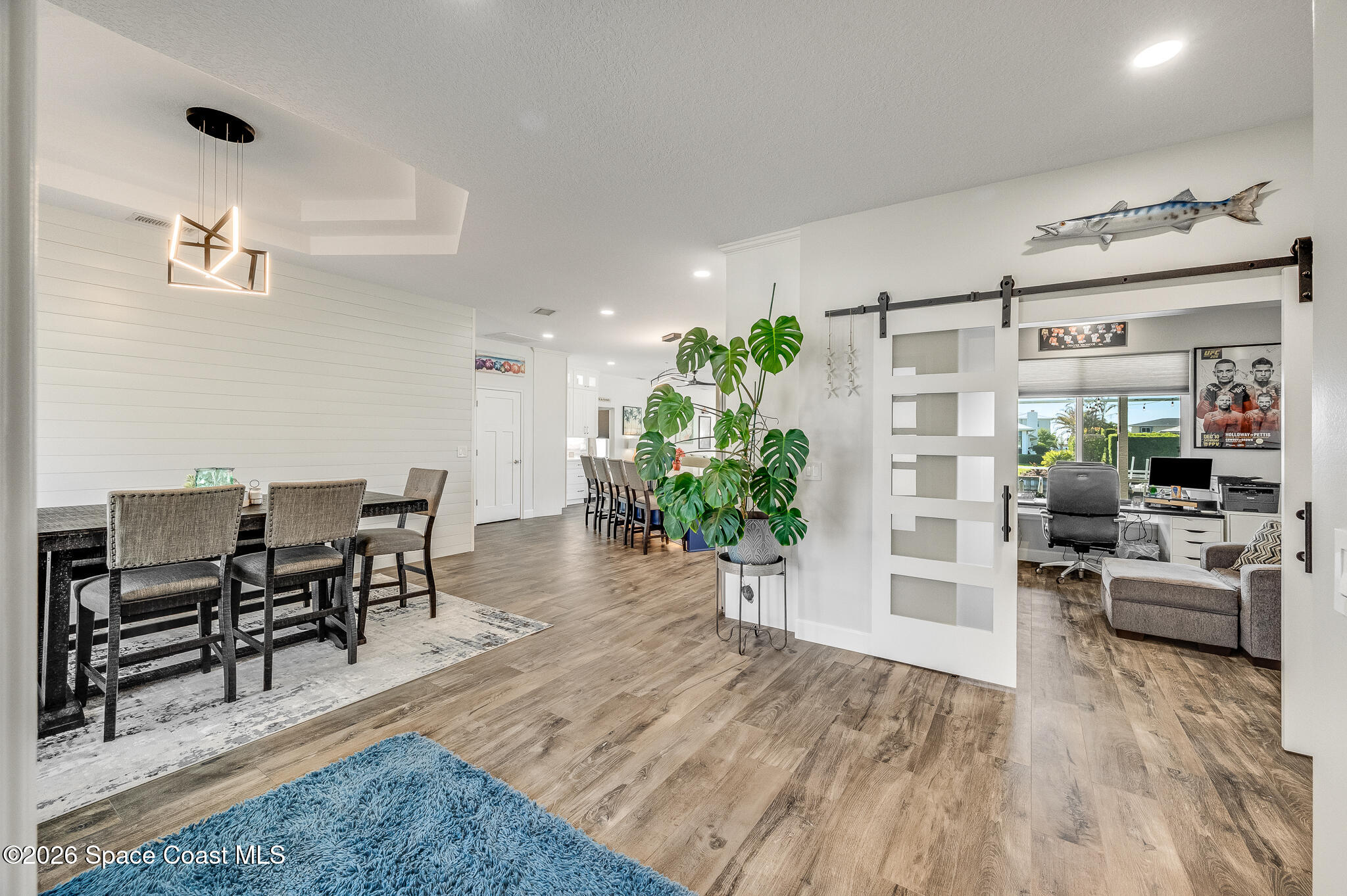 447 Sandy Key Melbourne Beach, FL 32951 - Photo 10 of 94 a view of a dining room with furniture a potted plant and wooden floor