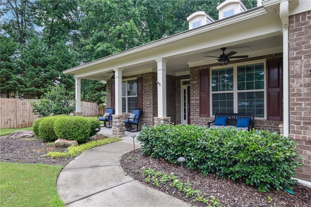 6255 Allison Road Cumming, GA 30040 - Photo 2 of 36 a house view with a garden space