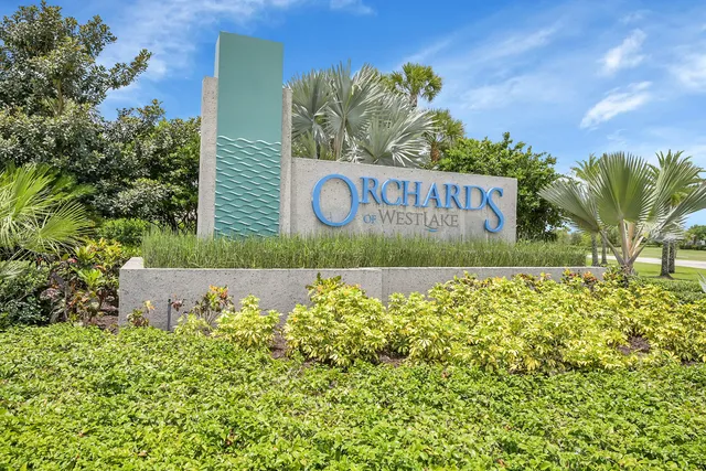 a front view of a house with a garden and plants