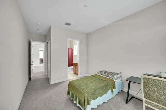 a bathroom with a granite countertop sink toilet a mirror and shower