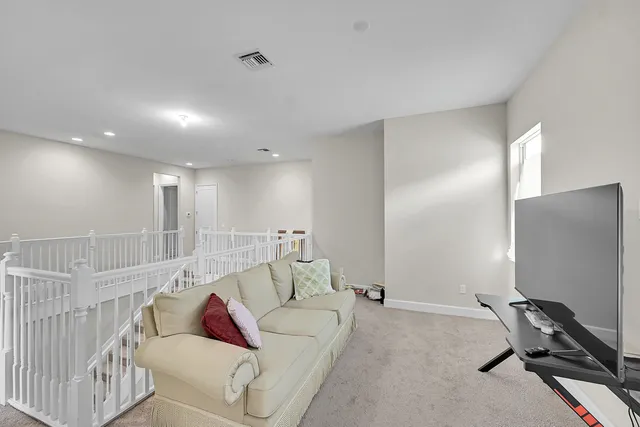 a swimming pool with outdoor seating yard and palm tree