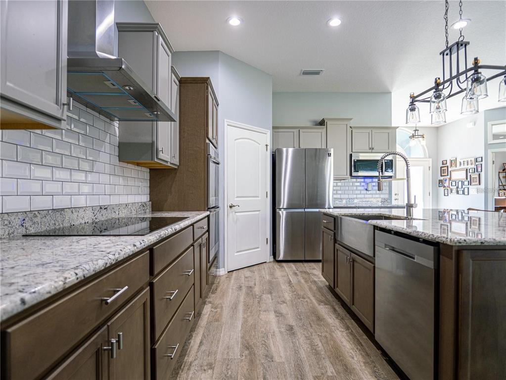 10688 Southwest 129th Terrace Road Dunnellon, FL 34432 - Photo 11 of 35 a kitchen with stainless steel appliances granite countertop a sink refrigerator and cabinets