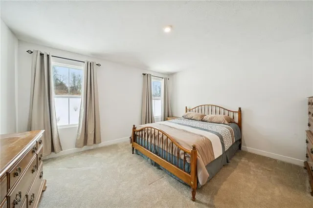 a spacious bedroom with a bed and a window