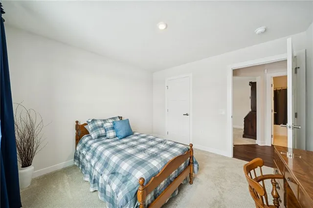a bedroom with a bed and balcony view