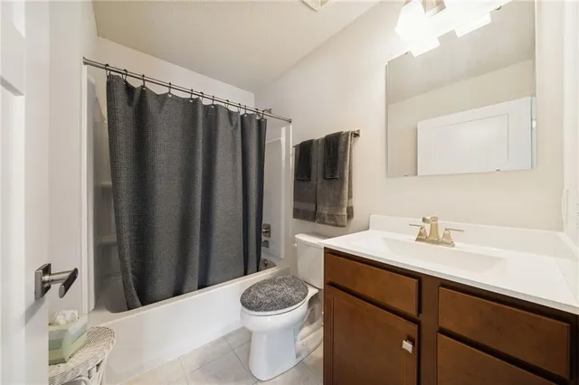 a bathroom with a sink a toilet a mirror and shower