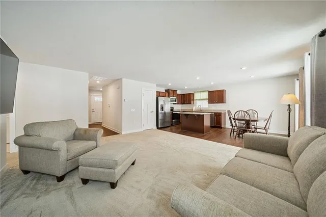 a living room with furniture and kitchen view