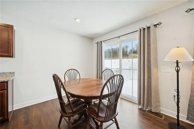 a dining room with furniture and wooden floor