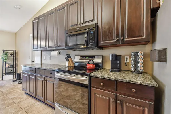 a kitchen with stainless steel appliances granite countertop a sink and cabinets