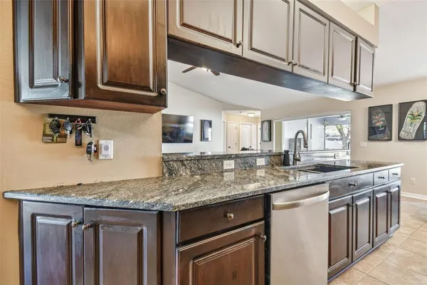 a kitchen with stainless steel appliances granite countertop a refrigerator and a sink
