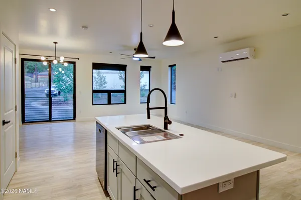 a kitchen with a stove a sink and a refrigerator