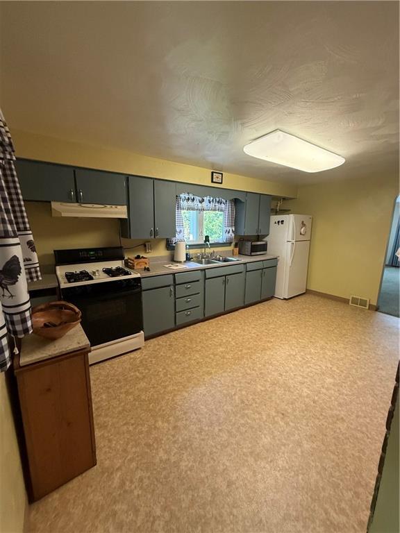 2801 7th Street Road New Kensington, PA 15068 - Photo 17 of 22 a kitchen with a stove a sink and a refrigerator