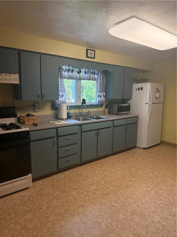 2801 7th Street Road New Kensington, PA 15068 - Photo 19 of 22 a kitchen with stainless steel appliances a sink a stove a refrigerator cabinets and a window