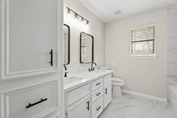 a bathroom with a double vanity sink mirror and double