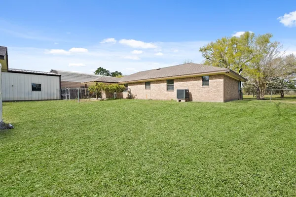 a big house with a big yard and large trees