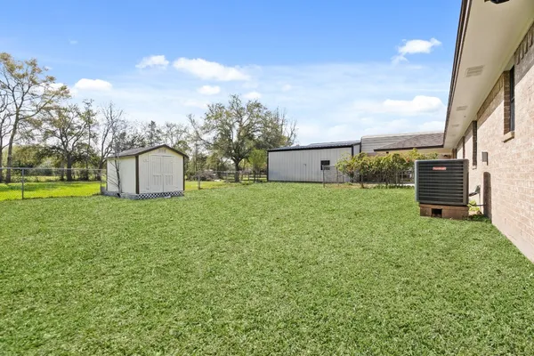 a backyard of a house with table and chairs