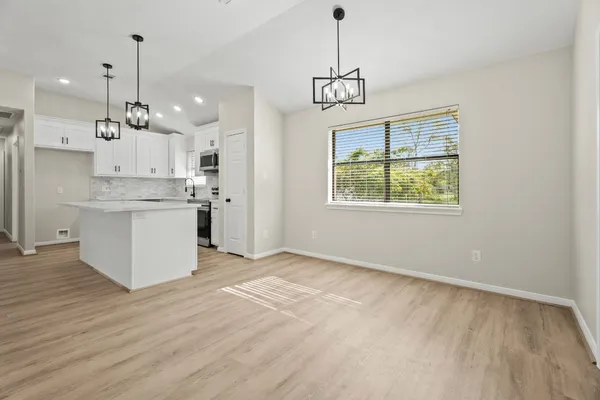 a view of a kitchen with a sink stainless steel appliances and cabinets