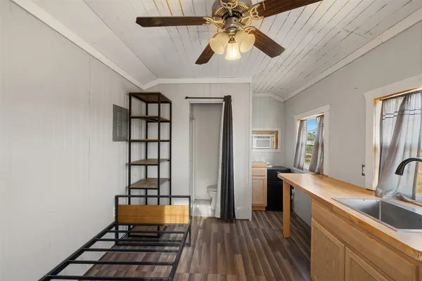 a kitchen with sink cabinets and wooden floor