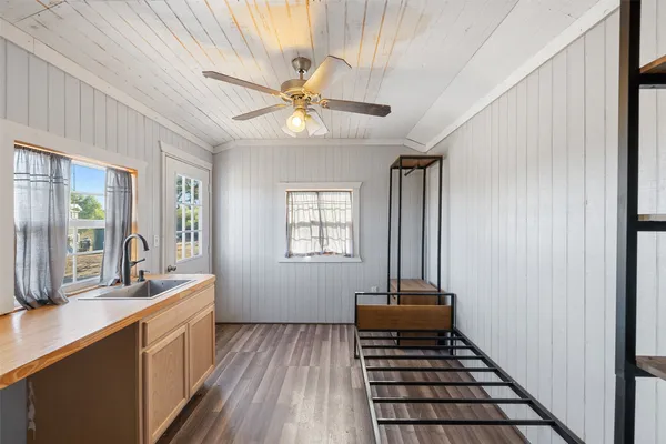 a spacious bathroom with a double vanity sink a mirror and a shower