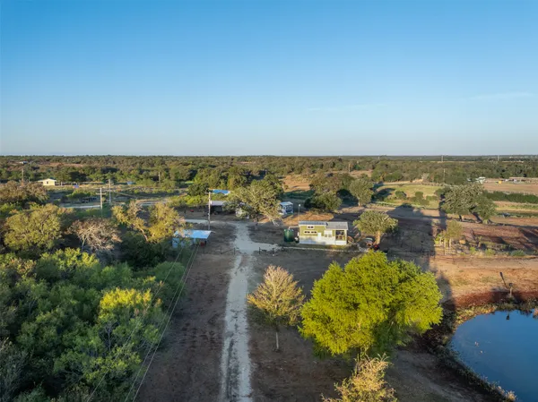 an aerial view of a house with a yard