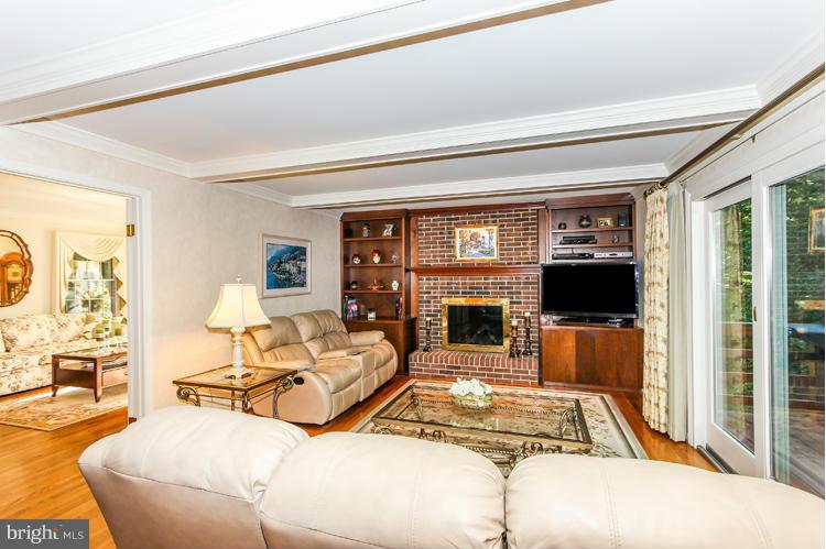 2600 Penny Royal Lane Reston, VA 20191 - Photo 12 of 30 a living room with furniture a flat screen tv and a fireplace