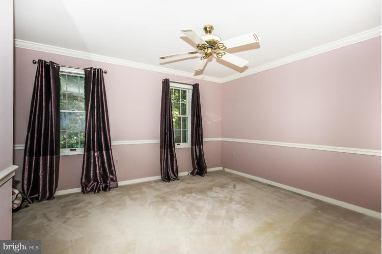 2600 Penny Royal Lane Reston, VA 20191 - Photo 19 of 30 an empty room with windows and a chandelier fan
