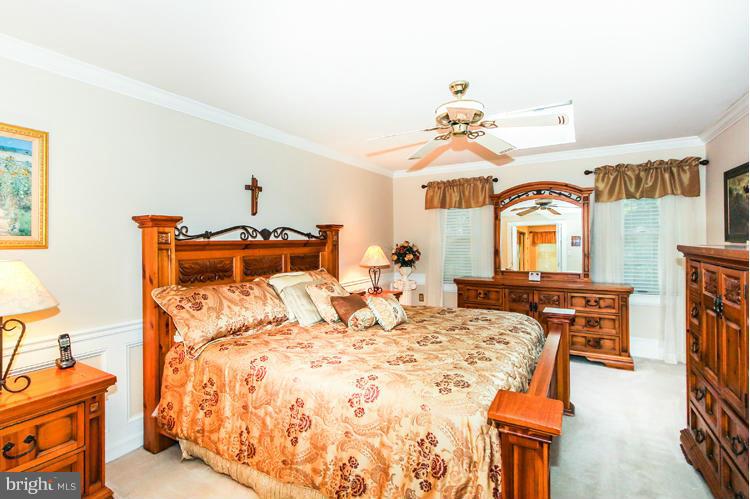 2600 Penny Royal Lane Reston, VA 20191 - Photo 22 of 30 a bedroom with a bed and ceiling fan