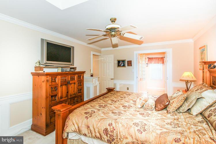 2600 Penny Royal Lane Reston, VA 20191 - Photo 23 of 30 a bedroom with a bed and a flat screen tv