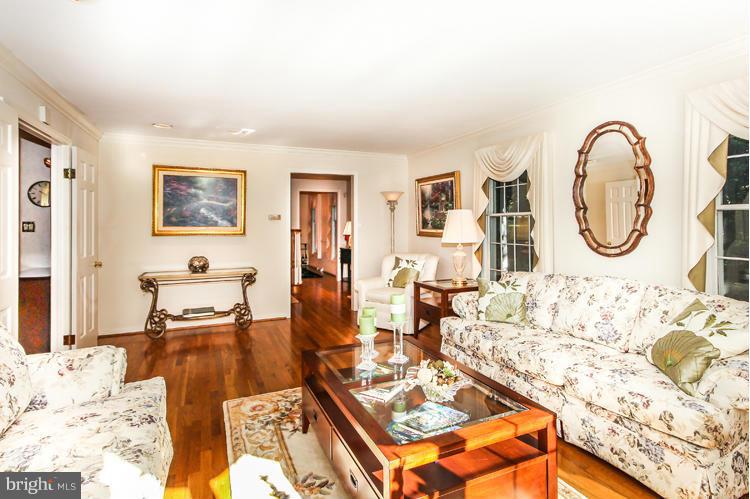 2600 Penny Royal Lane Reston, VA 20191 - Photo 9 of 30 a living room with furniture a flat screen tv and a table