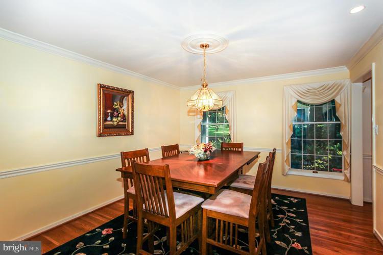 2600 Penny Royal Lane Reston, VA 20191 - Photo 10 of 30 a dining room with furniture a chandelier and wooden floor