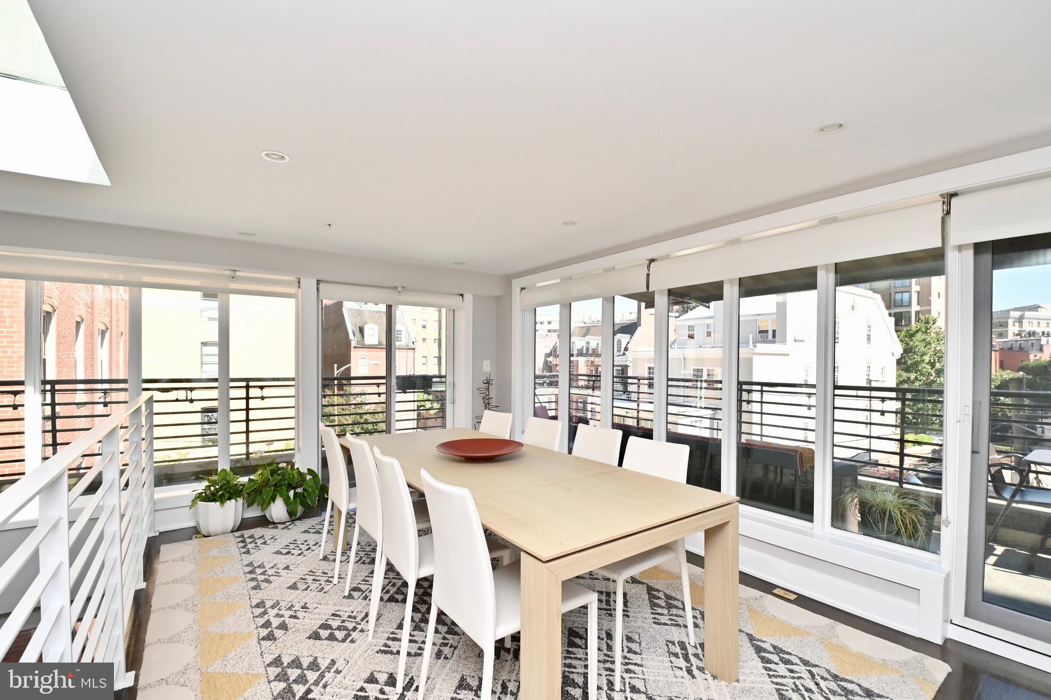 2012 Kalorama Road Northwest, Unit 8 Washington, DC 20009 - Photo 13 of 45 a view of a dining room with furniture large windows and wooden floor