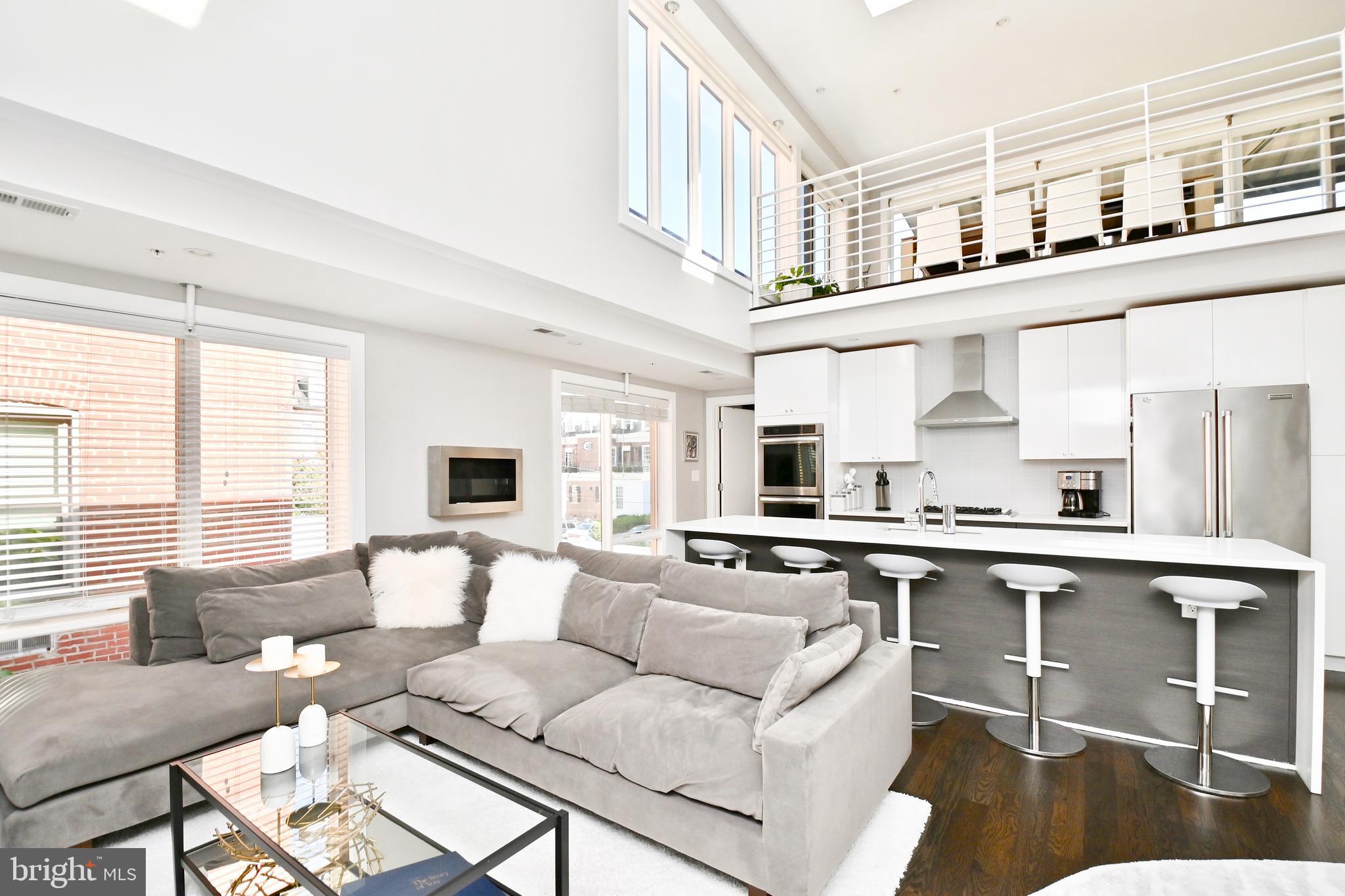 2012 Kalorama Road Northwest, Unit 8 Washington, DC 20009 - Photo 21 of 45 a living room with stainless steel appliances kitchen island furniture a rug and a large window