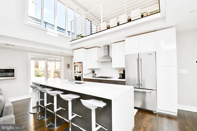 a kitchen with stainless steel appliances a sink and a refrigerator