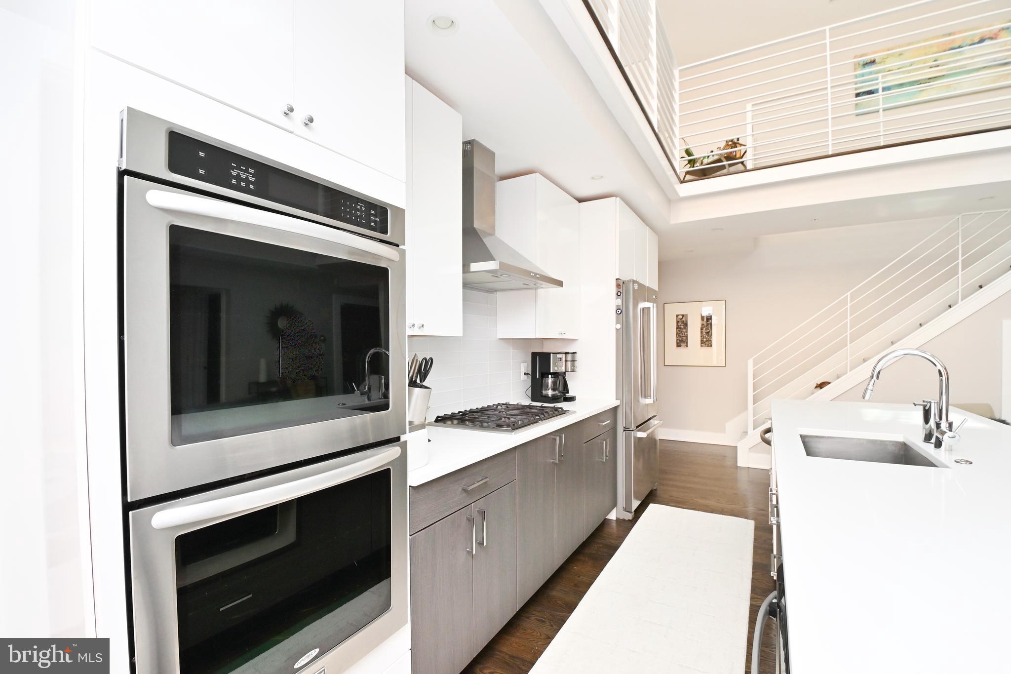 2012 Kalorama Road Northwest, Unit 8 Washington, DC 20009 - Photo 26 of 45 a kitchen with stainless steel appliances granite countertop a stove and a microwave