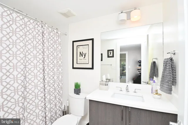 a bathroom with a toilet a sink and a mirror