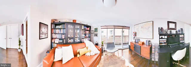 a view of a bedroom with wooden floor and windows