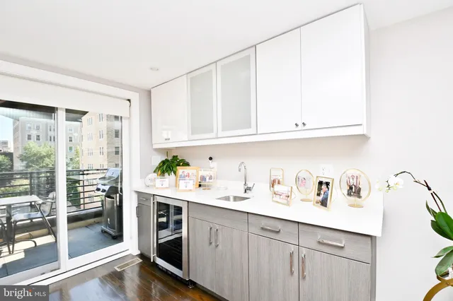 a kitchen with stainless steel appliances granite countertop a sink a stove and cabinets