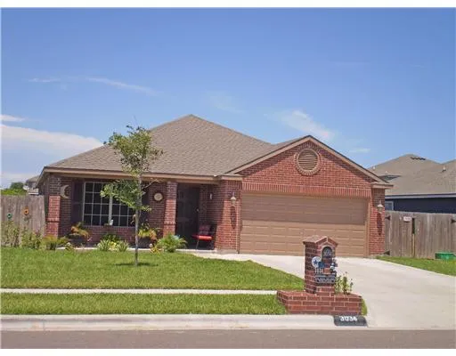 a front view of a house with a garden and plants