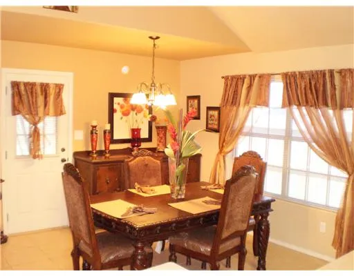 a view of a dining room with furniture and chandelier