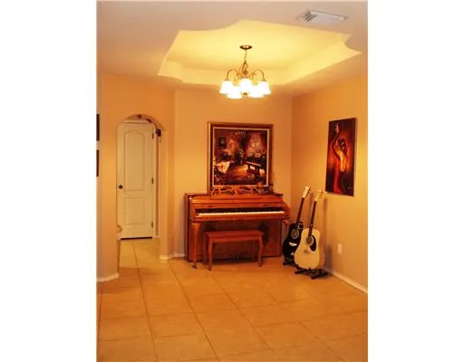 a view of a room with a large mirror and furniture