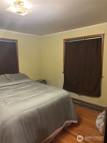 a bedroom with a bed and a painting on the wall