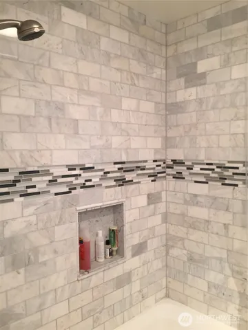 a room with granite countertop a white wall and a stove